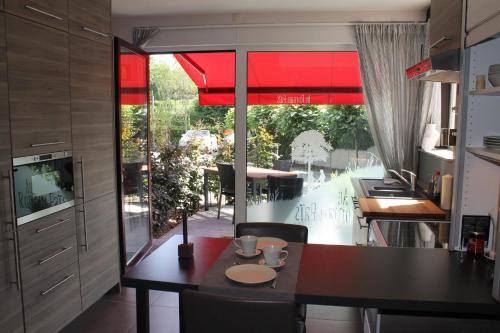 a kitchen with a table and a dining room at B&B Au Roman Païs in Braine-le-Château