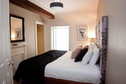 a bedroom with a bed with white sheets and pillows at 7 Boutique Hotel in Galway