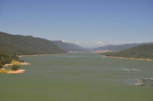 a view of a river with mountains in the background at EldoSport Hotel in Dospat