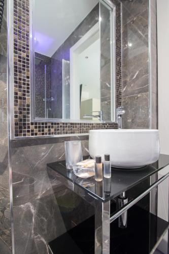 a bathroom with a sink and a mirror at Vatican Relais Rome in Rome