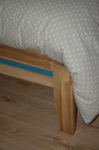 a close up of a bed with a white comforter at L'Horizon des Landes in Doazit