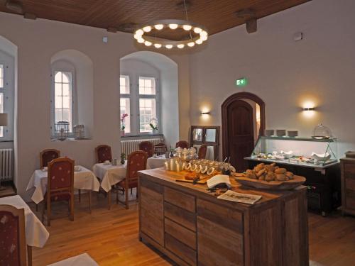 a dining room with tables and a buffet in a room at Schloss Spangenberg in Spangenberg