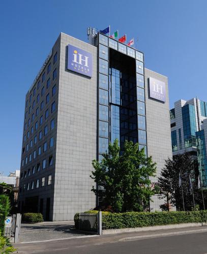 a building with a sign on the side of it at iH Hotels Milano Lorenteggio in Milan