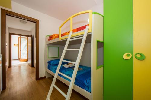 a bunk bed with a ladder in a room at Borgo La Sorgente - Erica in Gravedona