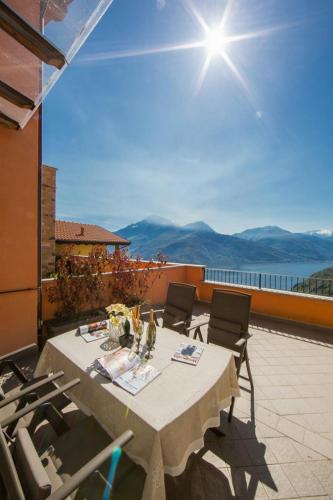a table and chairs on a patio with a view at Borgo La Sorgente - Erica in Gravedona