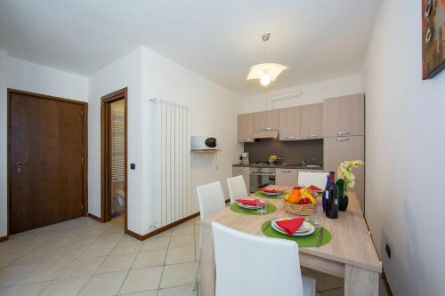 a kitchen and dining room with a table and chairs at Borgo La Sorgente - Erica in Gravedona