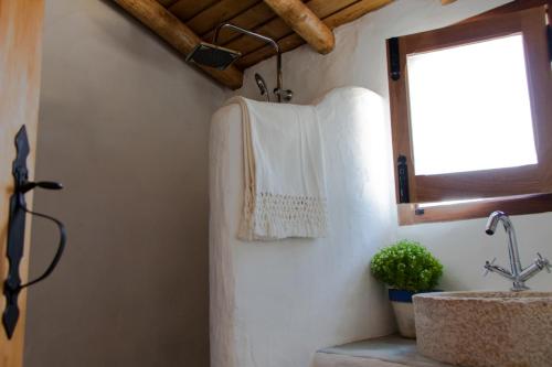 a bathroom with a sink and a towel on the wall at Monte Varandas in Arronches