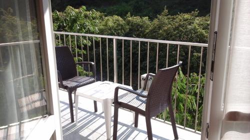 two chairs and a table on a porch at Bed & Breakfast 4U PARCHEGGIO INTERNO in Chiavari