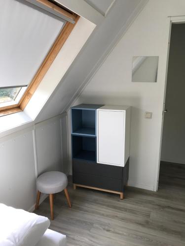 a bedroom with a bed and a desk and a window at Villa Anna with sauna in Winterswijk in Winterswijk