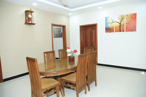 a dining room with a table and chairs at Superior rest in Jaffna