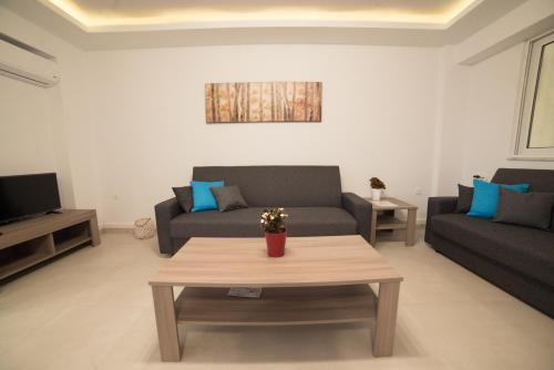 a living room with two couches and a coffee table at Bella Mare Luxury Apartments in Kalamaki Heraklion
