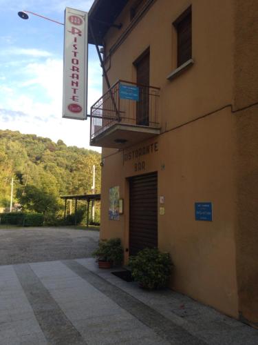 a building with a sign on the side of it at B&B Notte sul Lago in Gozzano