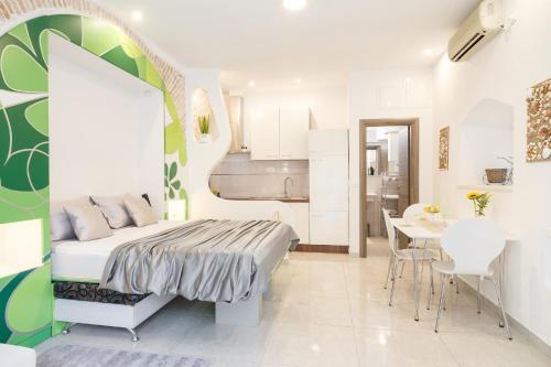 a bedroom with a bed and a dining room at Apartment Maleš in Split