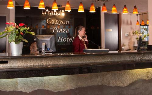 a man standing behind a bar with a microphone at Grand Canyon Plaza Hotel in Tusayan