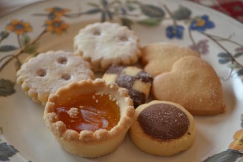 a plate of different types of pastries on a table at B&B La Tana dell'Orso - Die Bärenhöhle in Castello di Fiemme