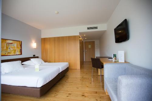 Ένα ή περισσότερα κρεβάτια σε δωμάτιο στο Monte Prado Hotel & Spa
