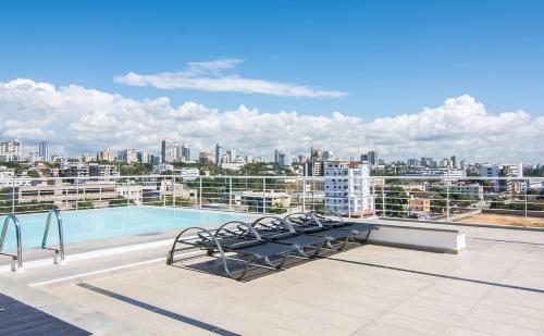 a large pool with a balcony overlooking a city at Loft Studio in Santo Domingo in Santo Domingo