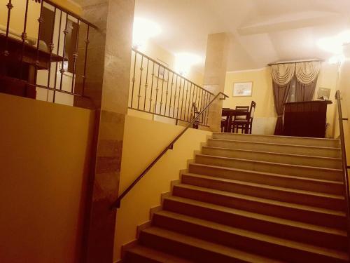 a staircase in a house with a stair case at Complex Turistic Gura Jgheabului in Oţelu Roşu