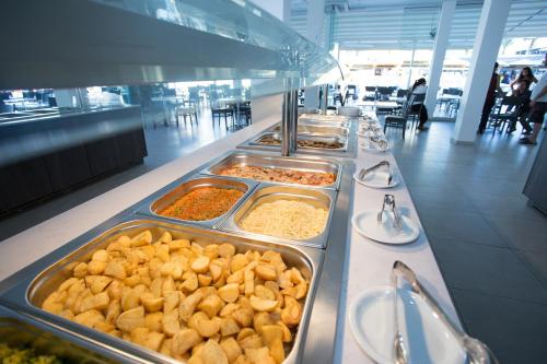 a buffet line with many trays of food at Mandali Hotel in Protaras