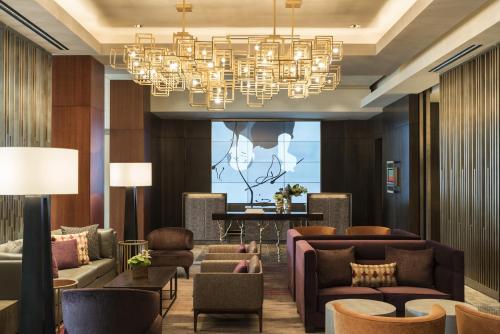 a hotel lobby with couches and a chandelier at Four Seasons Hotel Silicon Valley at East Palo Alto in Palo Alto