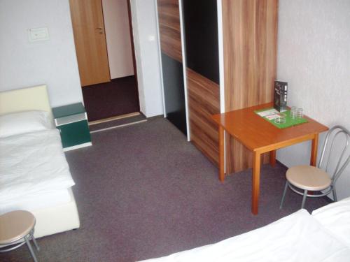a bedroom with a bed and a desk at Promohotel Slavie in Cheb