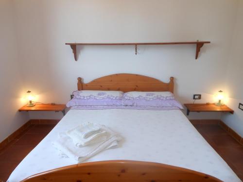 a bedroom with a large bed with two night stands at La Tavernetta in Masainas