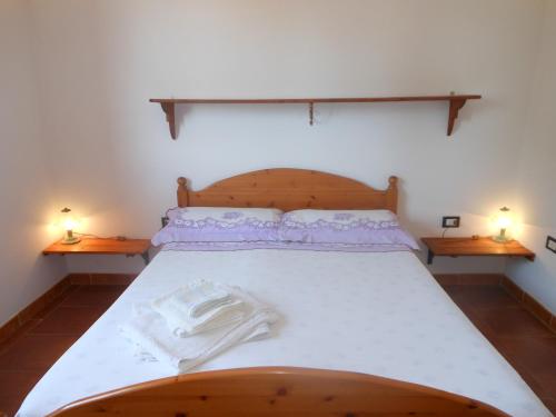 um quarto com uma cama grande e 2 mesas de cabeceira em La Tavernetta em Masainas