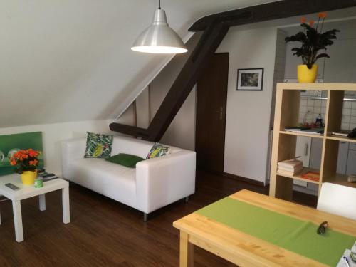 a living room with a white couch and a table at Interlaken Apartments in Interlaken