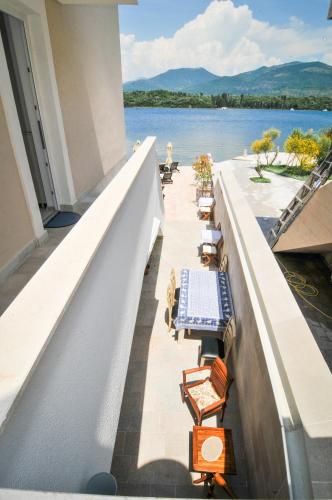 a balcony with chairs and a view of the water at Apartments Zukovac in Tivat