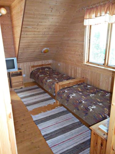 a small room with two beds in a cabin at Kotka Housing-FreeParking in Pärnu