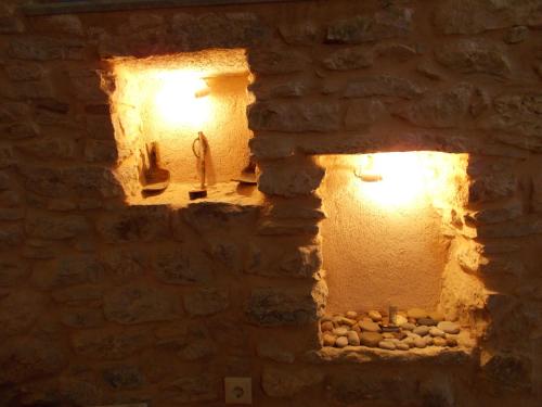 a stone wall with two lights in a room at Traditional Guest house Chrisyis in Pyrgi