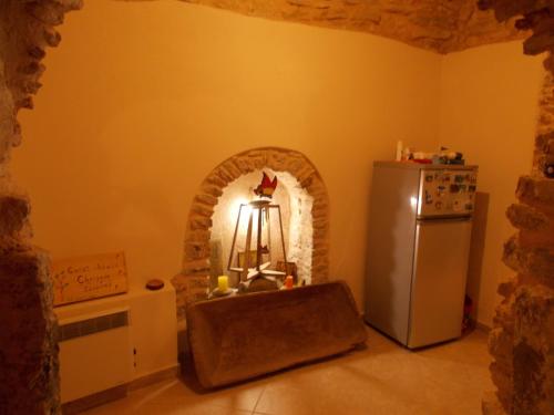 a kitchen with an archway with a refrigerator at Traditional Guest house Chrisyis in Pyrgi