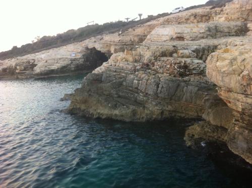 an aerial view of a rocky shore with blue water at Apartment Rustic Jolly in Premantura