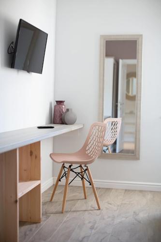 a white desk with a chair and a mirror at Villa Gellia in Ugljan