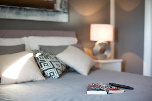 a bed with two books and a remote control on it at Villa Gellia in Ugljan