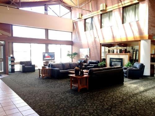 a large living room with couches and a fireplace at Ramada by Wyndham Cedar City in Cedar City