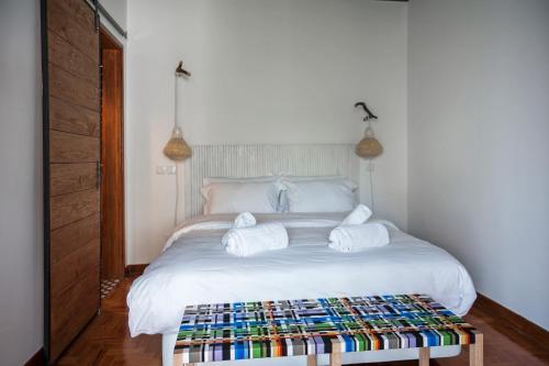 a bedroom with a white bed with towels on it at Lemon Tree Stay in Faro