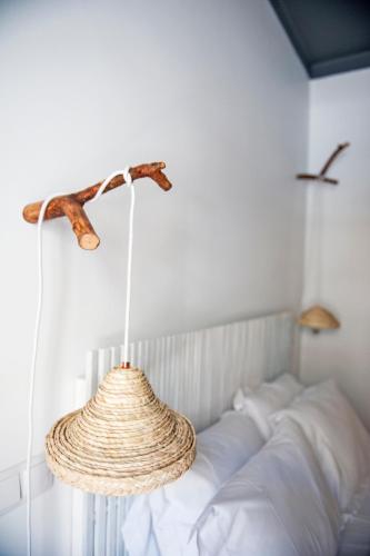 a chandelier hanging over a bed in a room at Lemon Tree Stay in Faro
