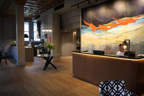 an office lobby with a large painting on the wall at Mrs Banks Hotel in Sydney