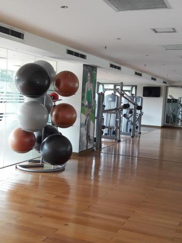 a room with a bunch of exercise equipment in a gym at Bluesky Serviced Apartment Airport Plaza in Ho Chi Minh City