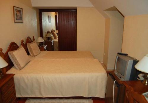 Ένα ή περισσότερα κρεβάτια σε δωμάτιο στο Hotel Jardim
