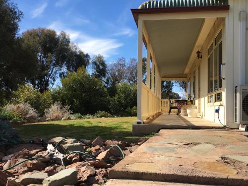 a porch of a house with a pile of rocks at Black Jack Get-A-Way "Magpies Nest" in Orroroo