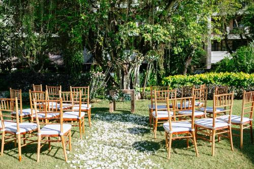 a group of chairs sitting in the grass at Novotel Bali Nusa Dua in Nusa Dua