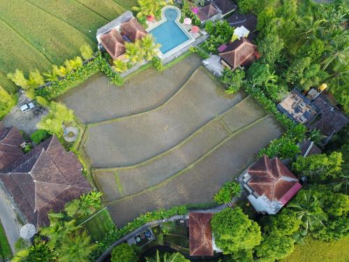 an overhead view of a house with a swimming pool at Atres Villa in Munduk