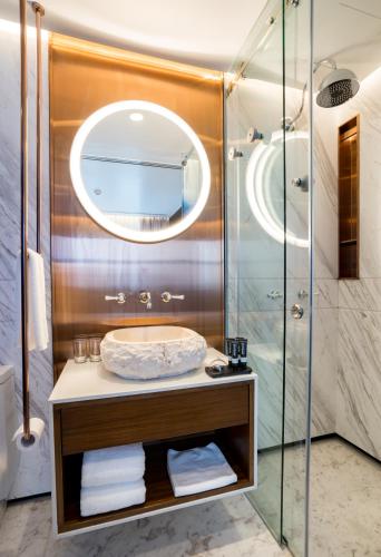 a bathroom with a sink and a shower at Tien Hotel Georgetown in George Town