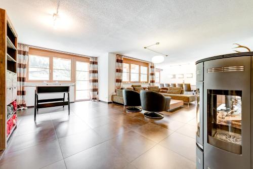 a living room with a couch and a fireplace at Gartenferienwohnung Ski In by A-Appartments in Brand