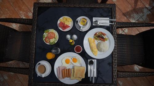 a tray of breakfast foods on a table at Villa Navin Beach Residence in Jomtien Beach