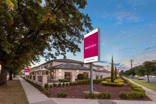 a pink sign in front of a house at Mercure Wagga Wagga in Wagga Wagga