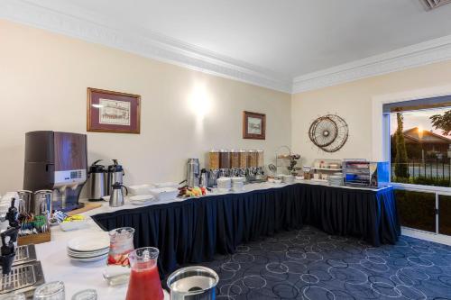 a table with a blue table cloth in a room at Mercure Wagga Wagga in Wagga Wagga