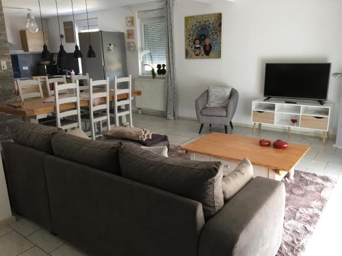 a living room with a couch and a table at Si le coeur vous en dit in Châtenois